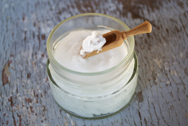 Clear jar filled with coconut oil to be swished in oil pulling to supposedly freshen breath