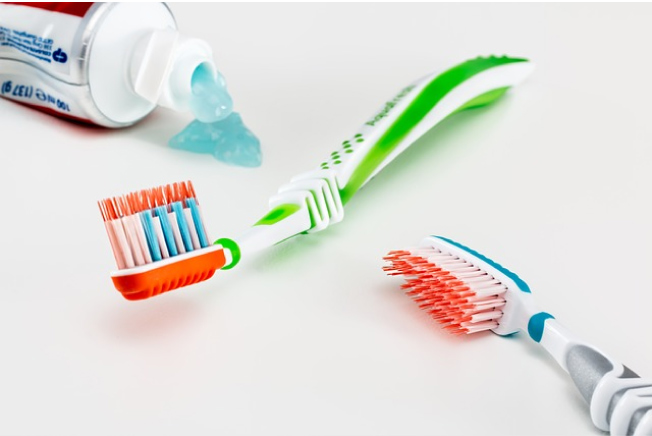 two toothbrushes with tube of toothpaste for healthy dental routine 