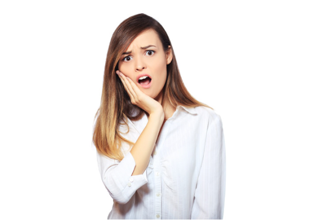 young woman holding her jaw in pain with a dental emergency