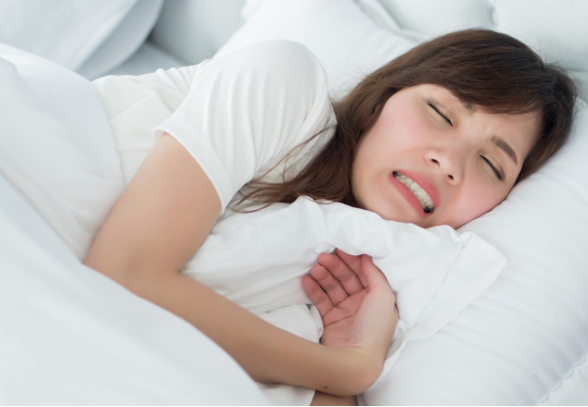woman grinds her teeth while sleeping