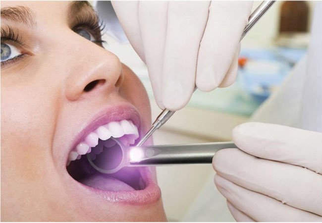 woman gets and oral cancer screening at the dentist office