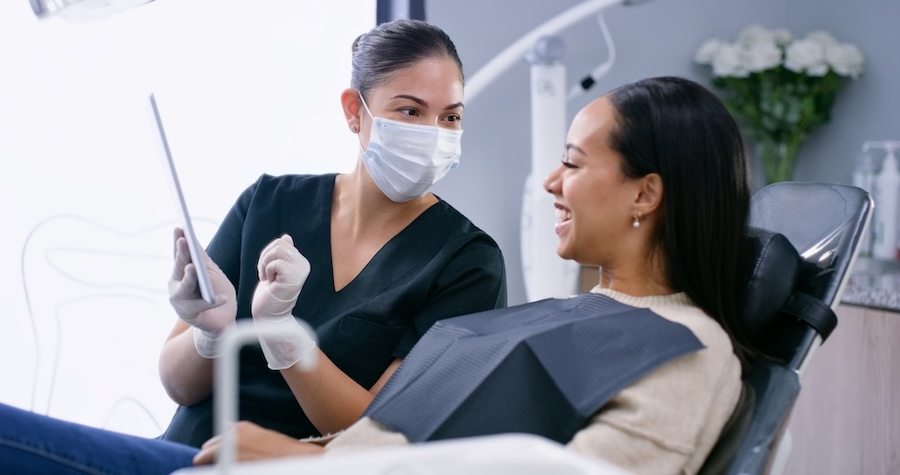 explaining dental insurance and dental savers plan to a patient at the dentist